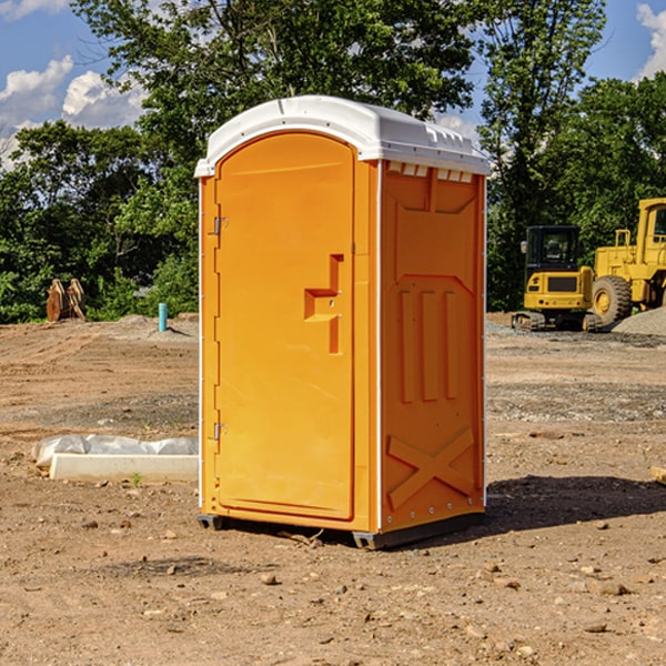 what is the cost difference between standard and deluxe portable restroom rentals in Amberg